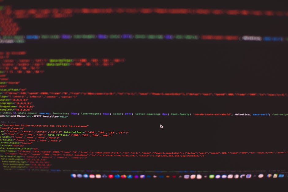 A black laptop positioned on a flat surface displaying a screen filled with lines of colorful code in shades of blue, red, and white, with a glow emanating from the screen reflecting subtle light on t
